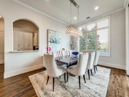 a dining room with furniture a chandelier and wooden floor