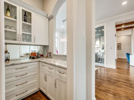 a kitchen with granite countertop white cabinets and white appliances