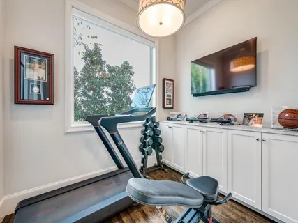 a view of a workspace with furniture and a flat screen tv