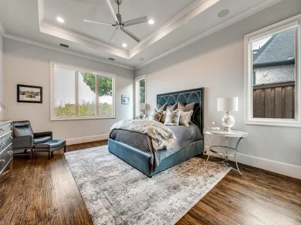 a bedroom with a bed wooden floor and window