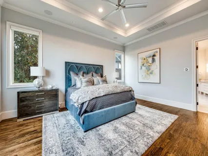 a bedroom with a large bed and a window