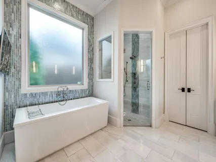 a bathroom with a bathtub and a shower