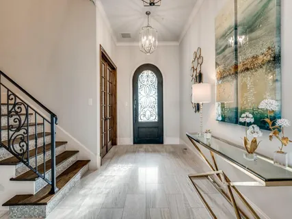 a hallway with couches and wooden floor