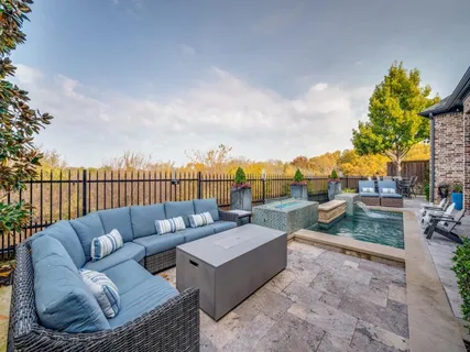 a roof deck with couches and potted plants with sky view