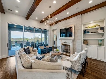 a living room with furniture fireplace and a large window