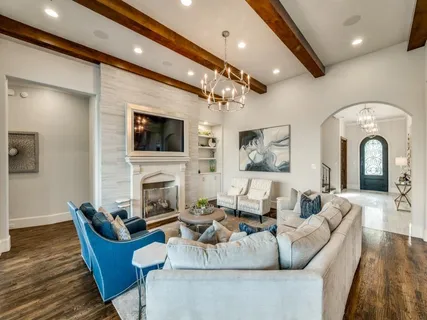 a living room with furniture a fireplace and a flat screen tv