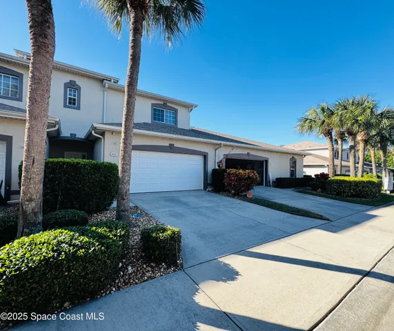 a front view of a house with a yard and a garage