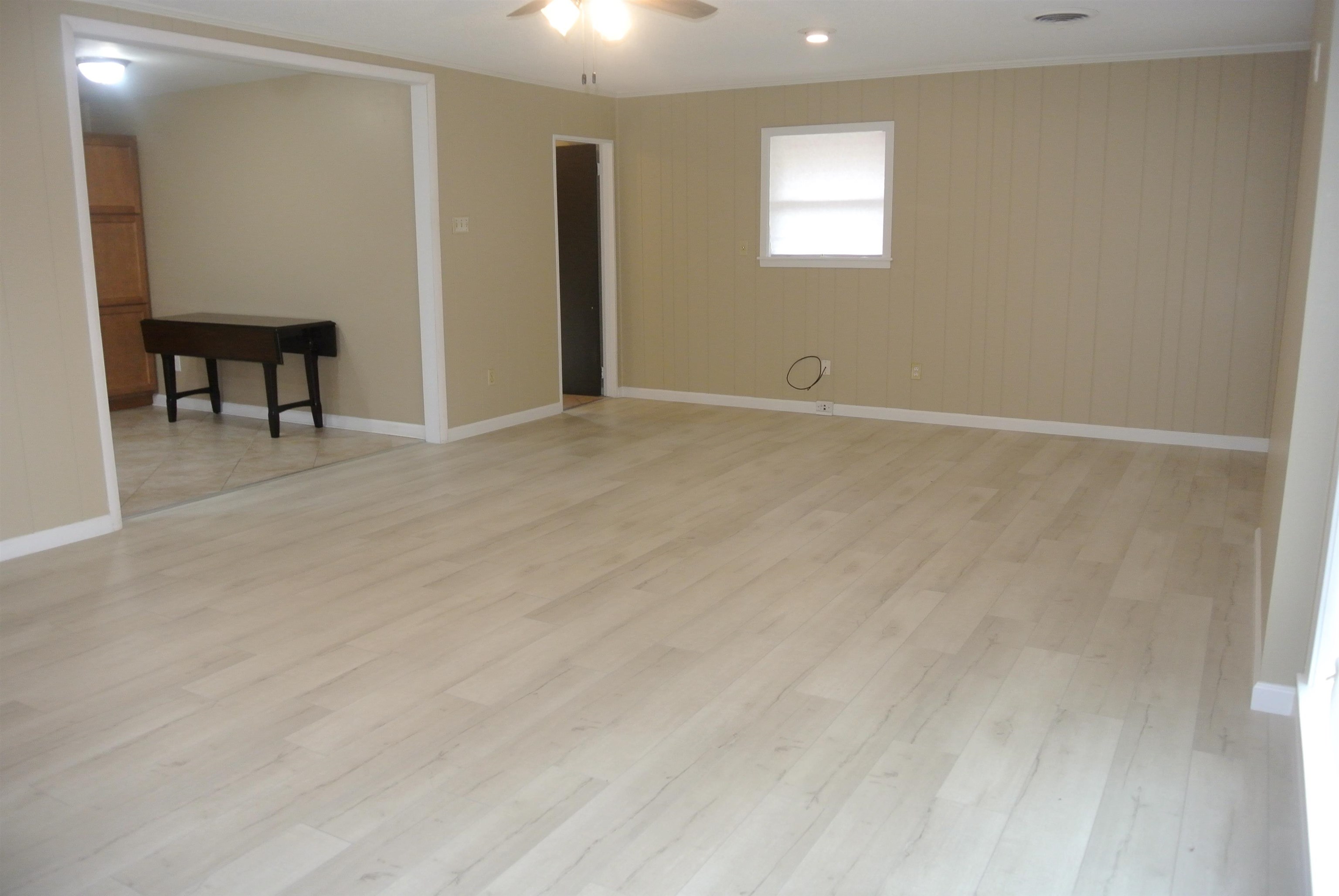 426 Cardinal Drive Collierville, TN 38017 - Photo 11 of 21 a view of an empty room with wooden floor and a window