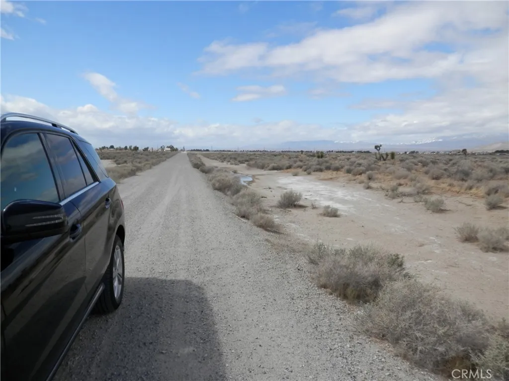 0 Gaskell Road Rosamond, CA 93560 - Photo 7 of 20 a view of a dry yard with wooden fence