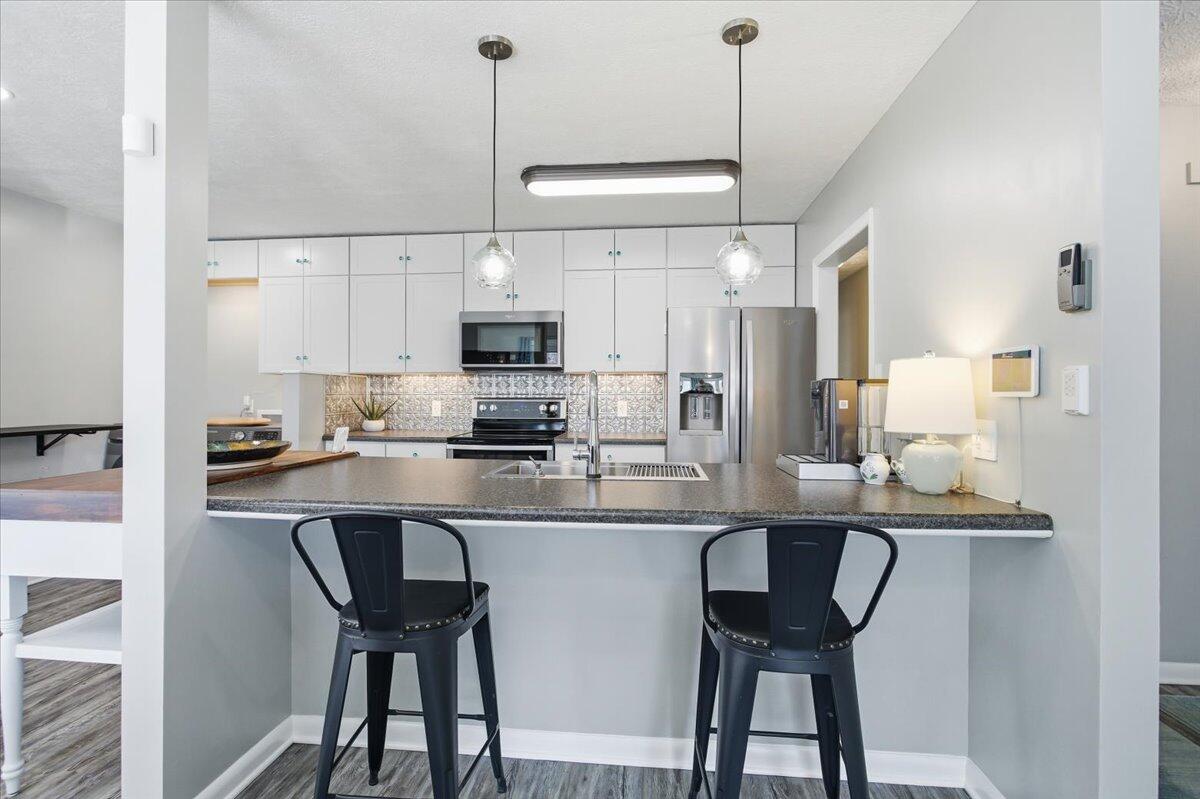 128 Huntington Road Ridgeway, VA 24148 - Photo 22 of 60 a kitchen with stainless steel appliances a table chairs refrigerator and microwave
