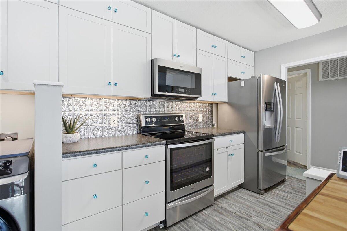 128 Huntington Road Ridgeway, VA 24148 - Photo 23 of 60 a kitchen with granite countertop a refrigerator stove and white cabinets