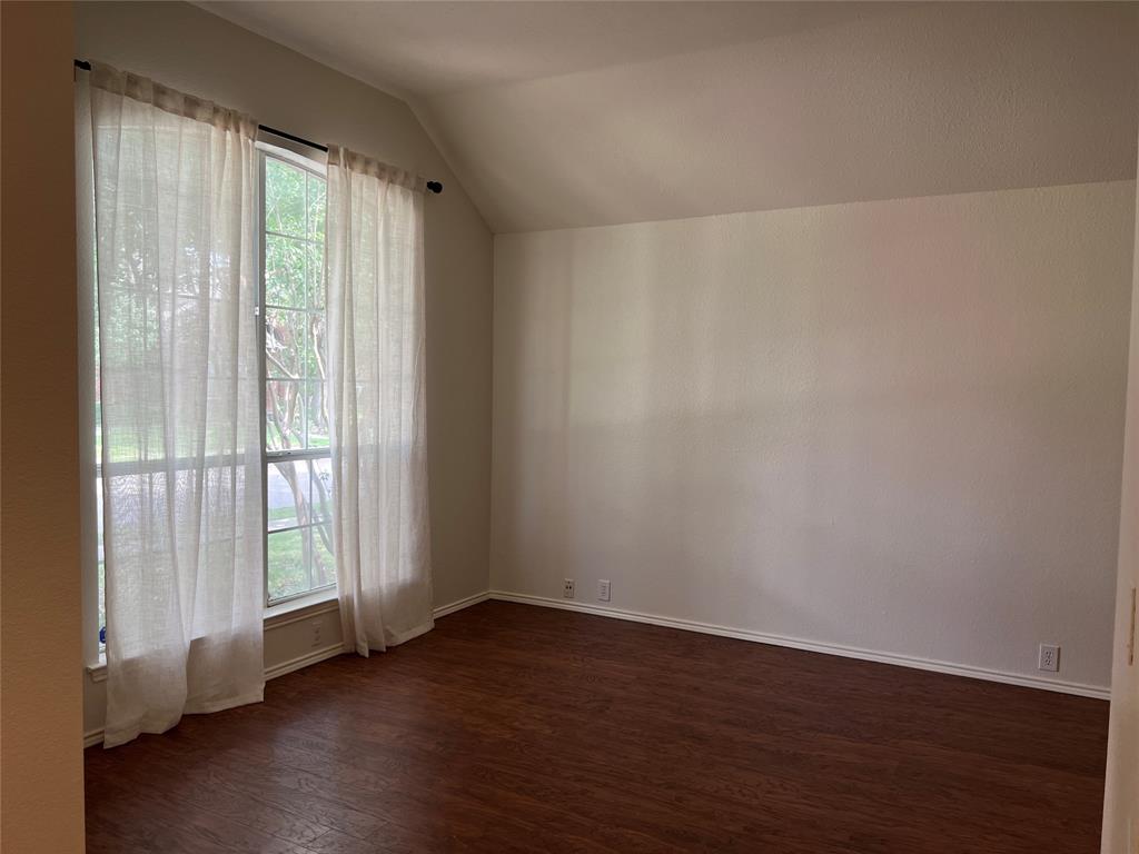 334 Touchdown Drive Irving, TX 75063 - Photo 5 of 32 Bright interior space featuring wood-finish flooring, neutral-toned walls, and a large multi-pane window with sheer coverings