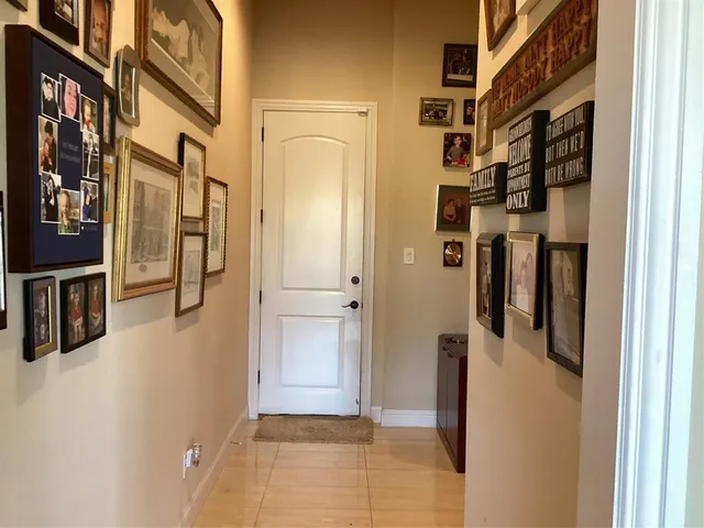 a kitchen with granite countertop a table chairs microwave and cabinets