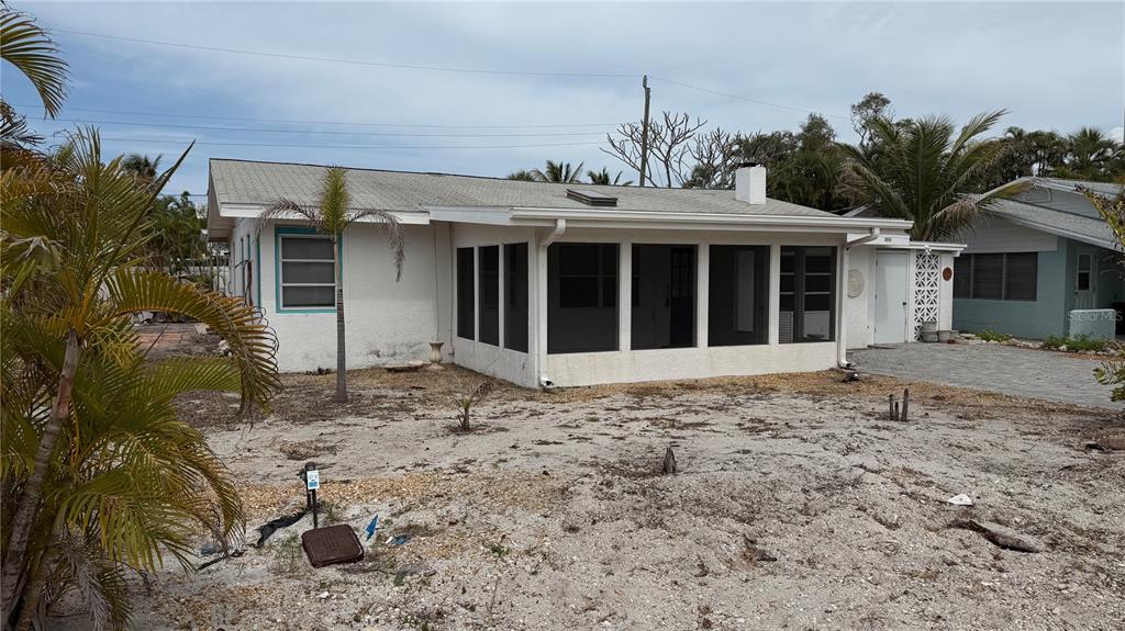 114 78th Street Holmes Beach, FL 34217 - Photo 14 of 25 a front view of a house with a yard