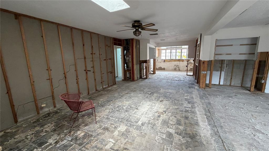 114 78th Street Holmes Beach, FL 34217 - Photo 15 of 25 a view of a livingroom with wooden floor and a ceiling fan