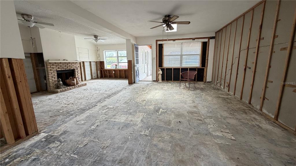 114 78th Street Holmes Beach, FL 34217 - Photo 22 of 25 a view of an empty room with a fireplace and a window