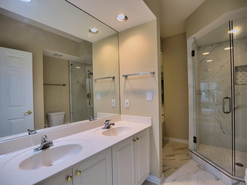 3636 Habersham Road Northwest, Unit 2308 Atlanta, GA 30305 - Photo 18 of 42 a bathroom with a shower sink double and mirror