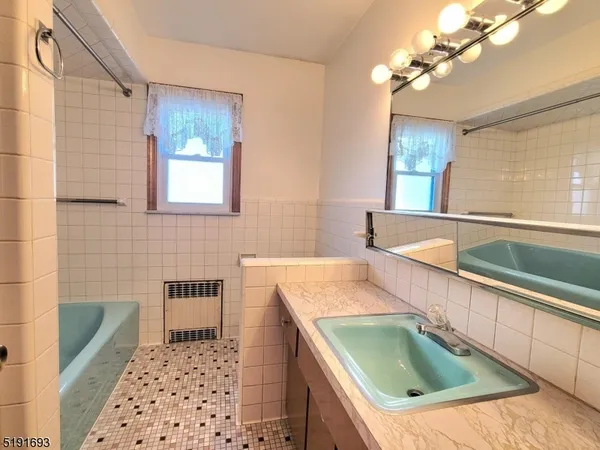 a kitchen with a sink a counter top space and living room