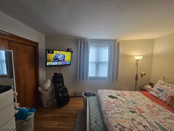 a bedroom that has a bed and a chair in it