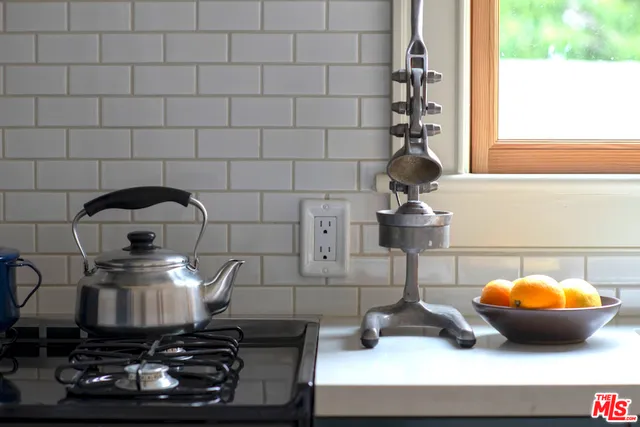 a kitchen with a stove and cabinets