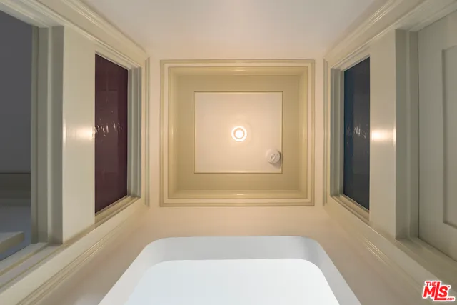 a view of a hallway with wooden floor and a fireplace