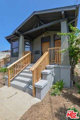 a view of a house with wooden fence