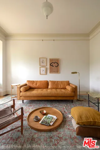 a living room with furniture and a lamp