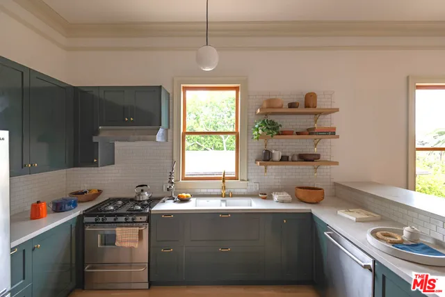 a kitchen with a sink cabinets and window