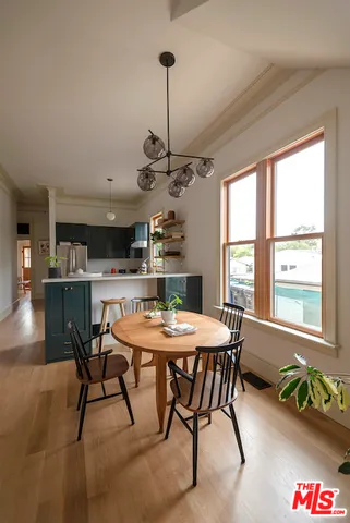 a view of a dining room with furniture window and wooden floor