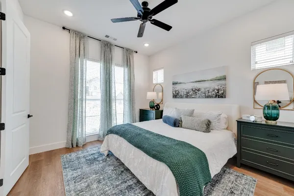 a bedroom with a large bed and a chandelier