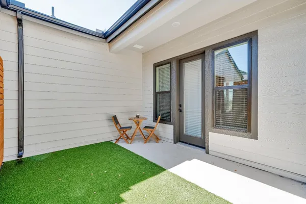 a backyard of a house with outdoor seating