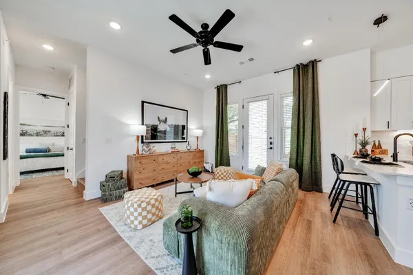 a living room with furniture and wooden floor
