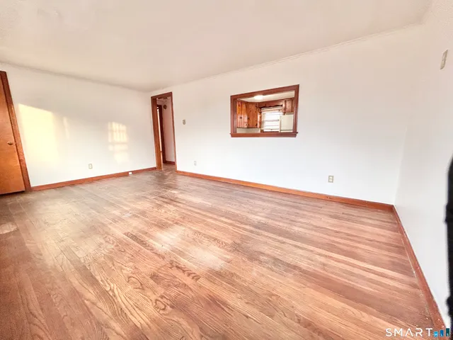 a room with a bed furniture and a large window