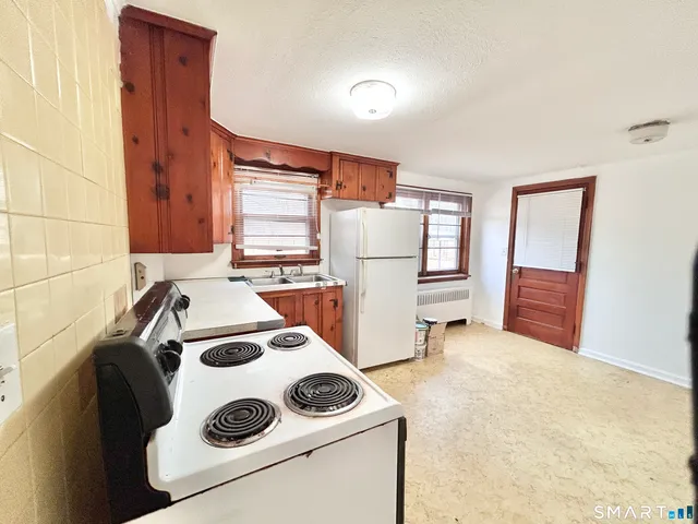 a living room with a couch and a dresser next to a window