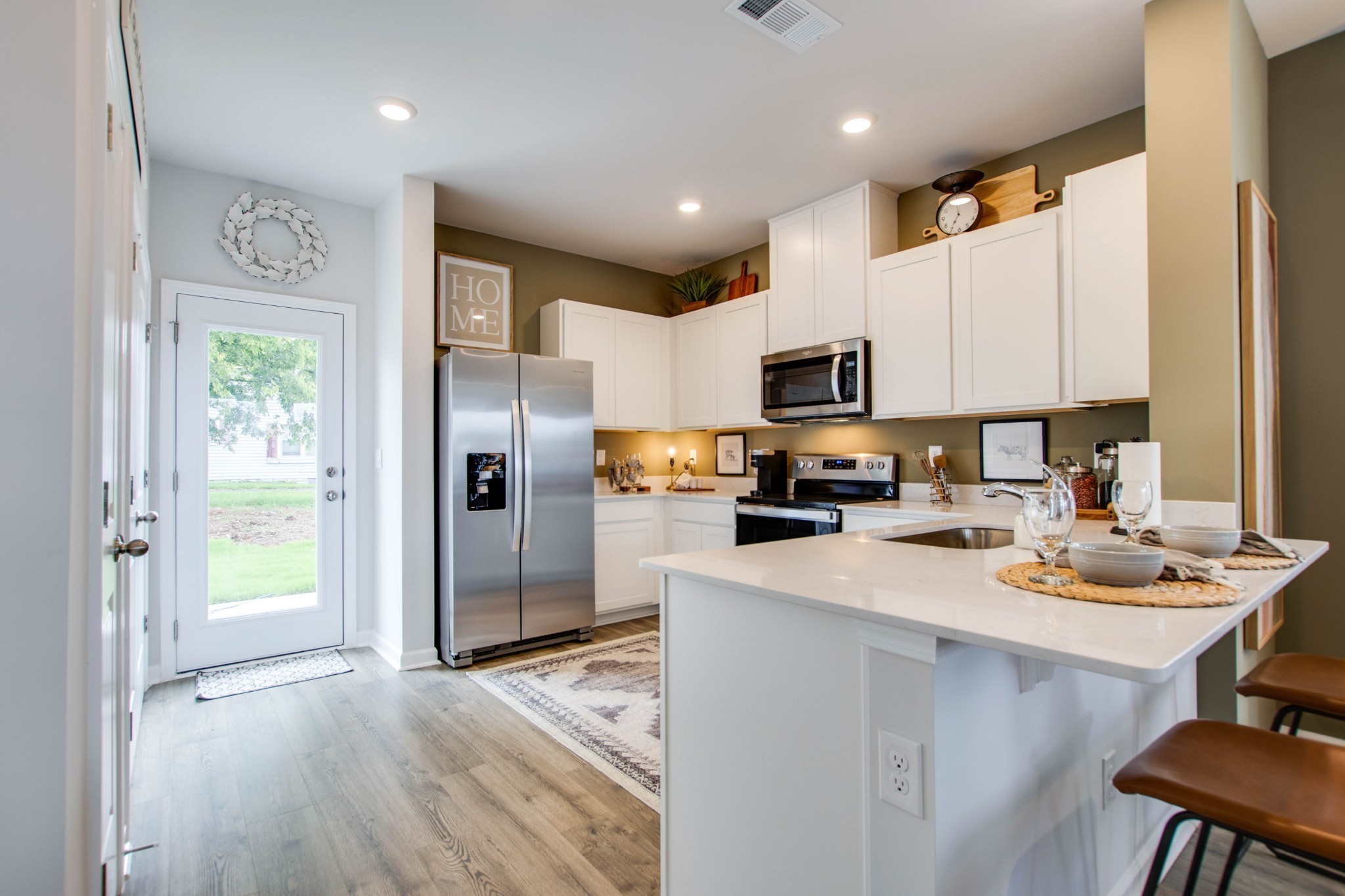 258 Hazel Lane Lebanon, TN 37087 - Photo 6 of 37 a kitchen with a refrigerator a sink dishwasher and a stove with wooden floor