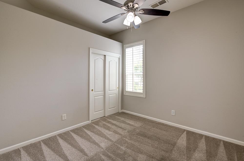 3235 Rall Avenue Clovis, CA 93619 - Photo 21 of 33 an empty room with windows and fan