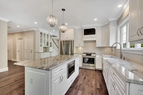 a kitchen with stainless steel appliances granite countertop a stove and a sink