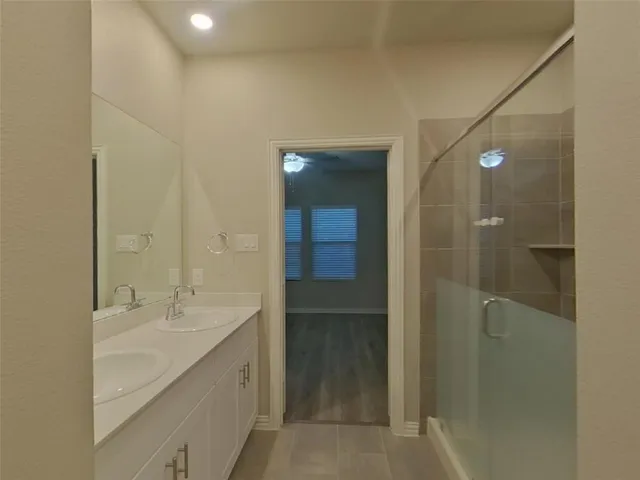 a bathroom with a double vanity sink and mirror