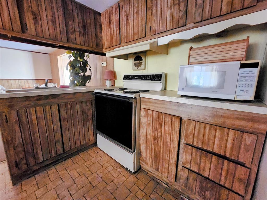 13022 East Shawnee Trail Inverness, FL 34450 - Photo 16 of 80 a kitchen with stainless steel appliances granite countertop wooden cabinets a stove top oven a sink and dishwasher