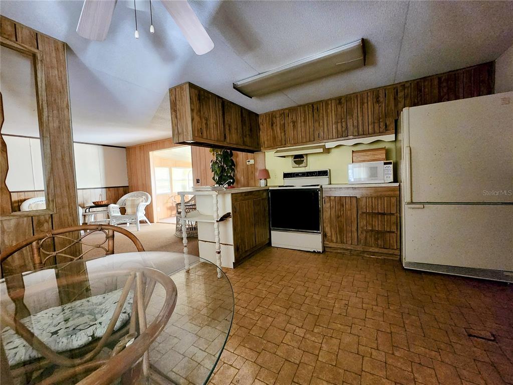 13022 East Shawnee Trail Inverness, FL 34450 - Photo 18 of 80 a kitchen with stainless steel appliances kitchen island granite countertop a refrigerator and a stove top oven