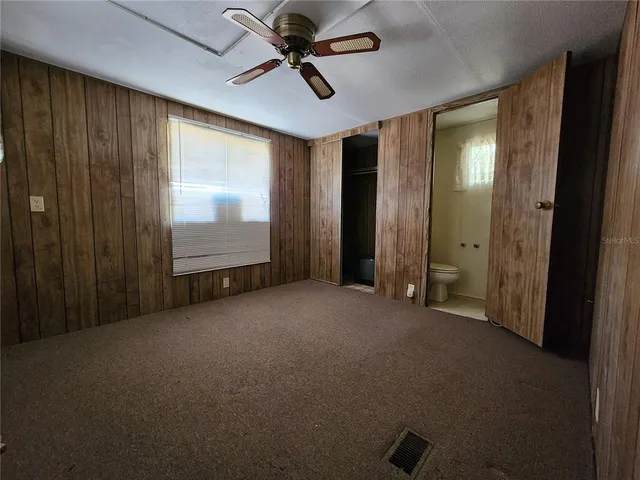 a view of a closet with wooden floor