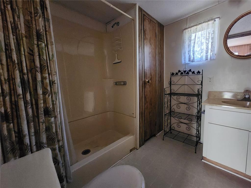 13022 East Shawnee Trail Inverness, FL 34450 - Photo 25 of 80 a bathroom with a shower and a sink