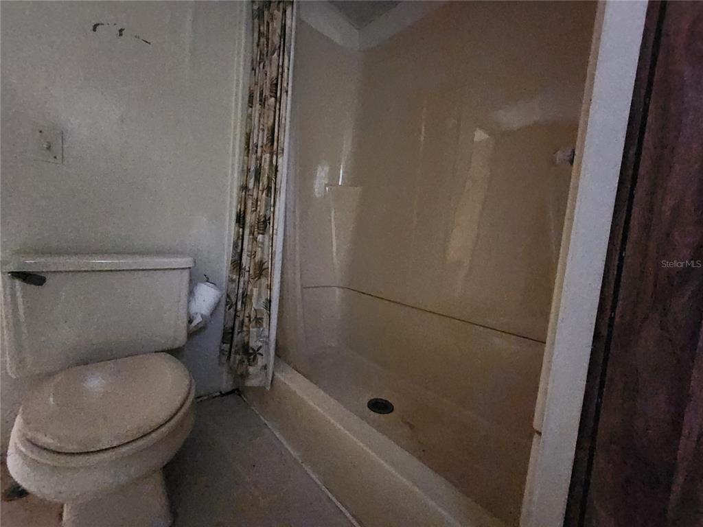 13022 East Shawnee Trail Inverness, FL 34450 - Photo 26 of 80 a bathroom with a toilet and a shower