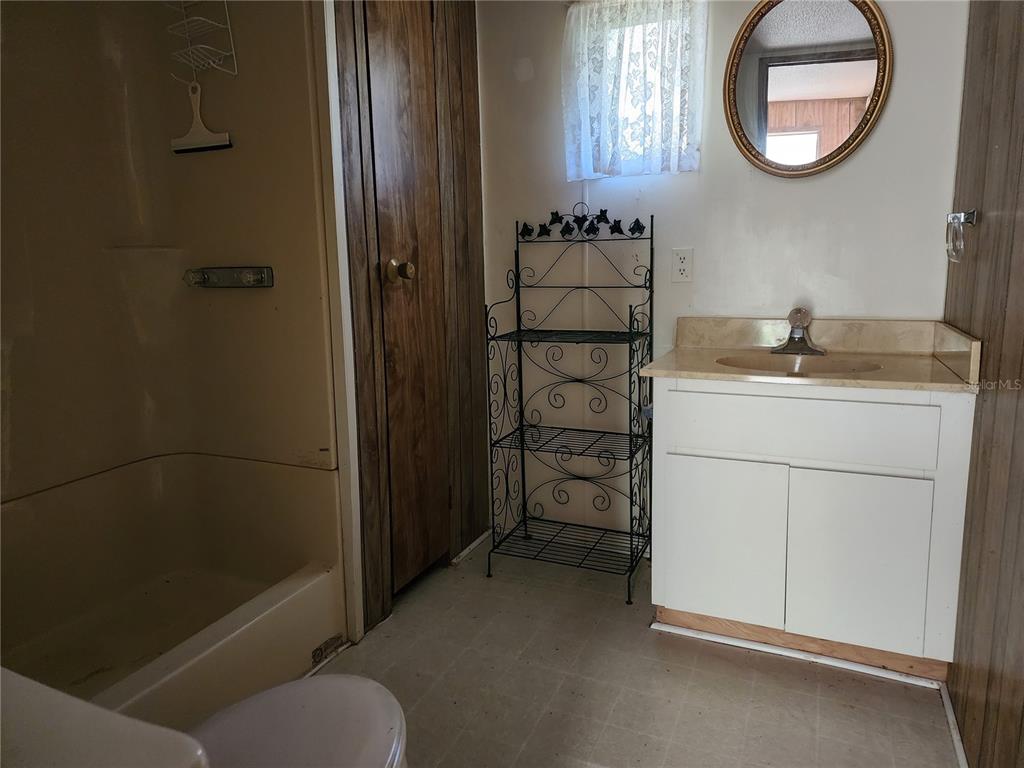 13022 East Shawnee Trail Inverness, FL 34450 - Photo 28 of 80 a bathroom with a granite countertop sink toilet and shower
