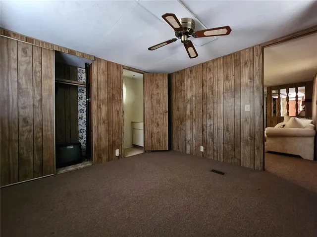 a bedroom with furniture and a large window