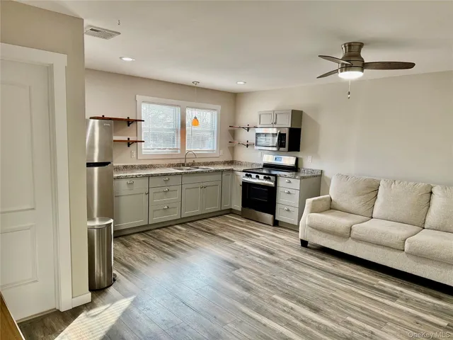 a view of kitchen with sink microwave and stove
