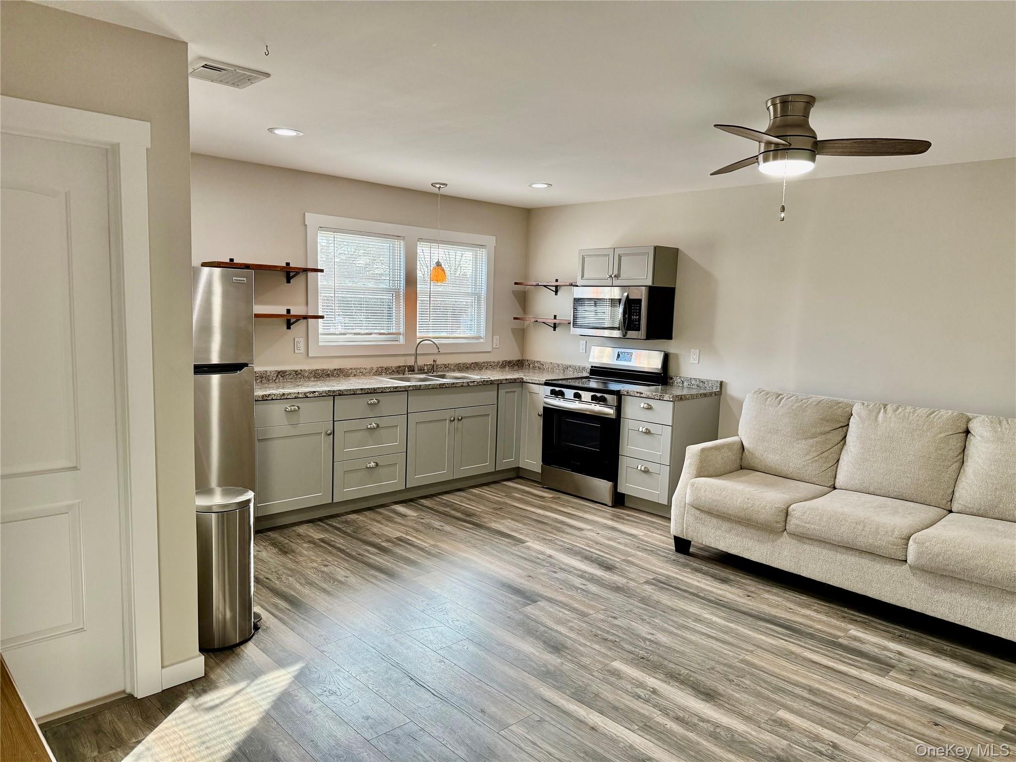 a view of kitchen with sink microwave and stove