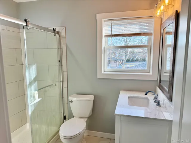 a white toilet sitting next to a bathroom sink