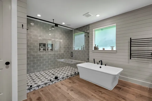a bathroom with a bathtub shower sink and a toilet