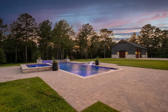 an outdoor space with swimming pool and furniture